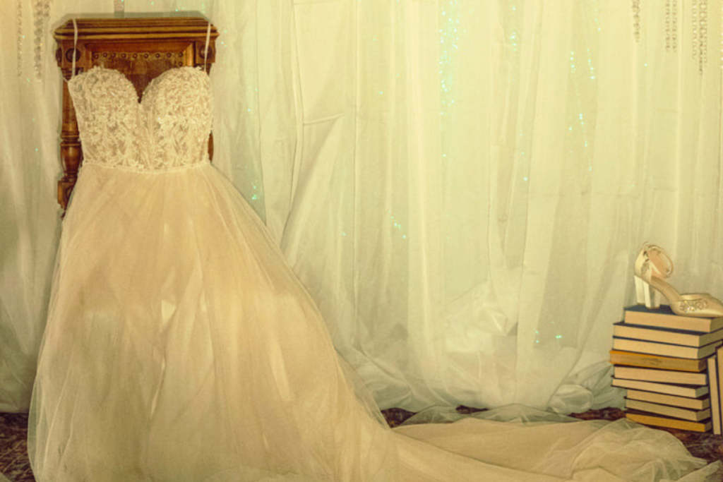 Strapless lace ballgown wedding dress with full tulle skirt displayed at a bridal boutique in Oklahoma, styled for wedding day tips inspiration.