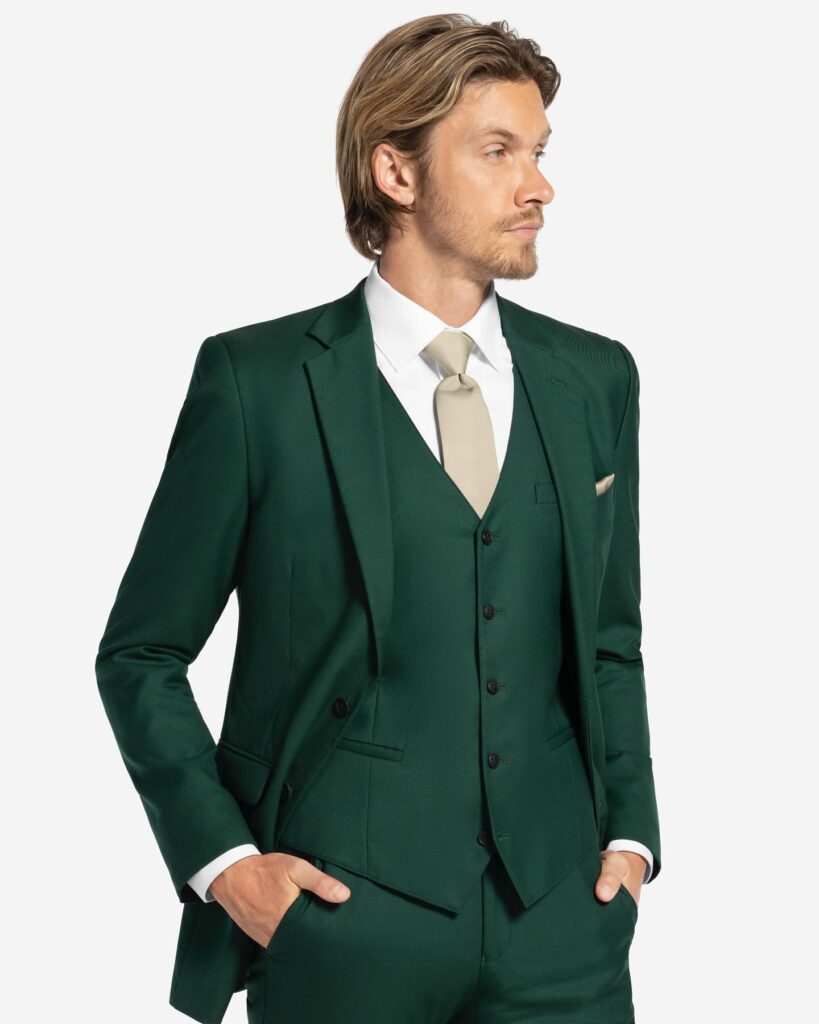 Model wearing a modern green suit from a bridal boutique partnership where couples shop bridal and coordinate designer bridal gowns and formalwear.