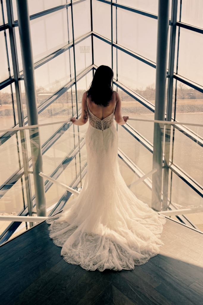 Back view of bride in designer bridal gown from our bridal boutique, perfect for brides who want to shop bridal styles with dramatic trains.