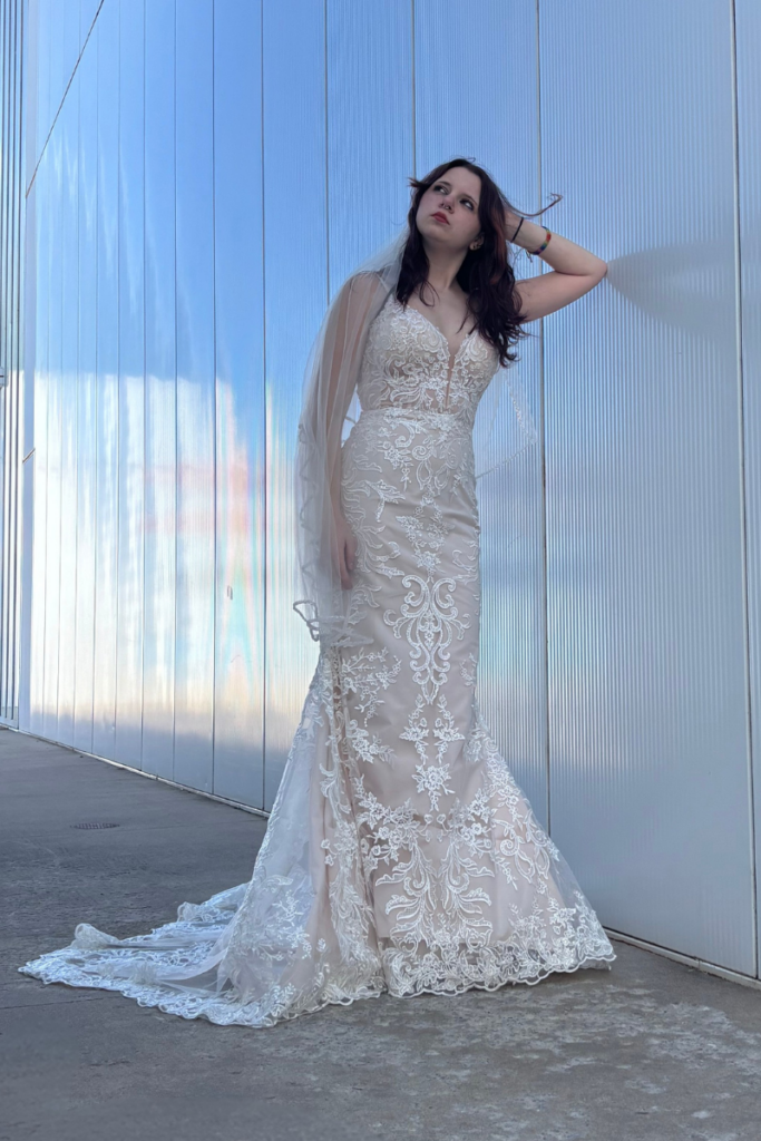 Bride wearing a lace designer bridal gown from our bridal boutique, inviting brides to shop bridal styles with modern elegance.