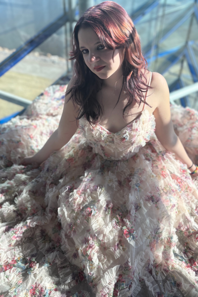 Floral quinceanera dress from our consignment prom collection, styled as a romantic prom dress with layered tulle and ruffles.