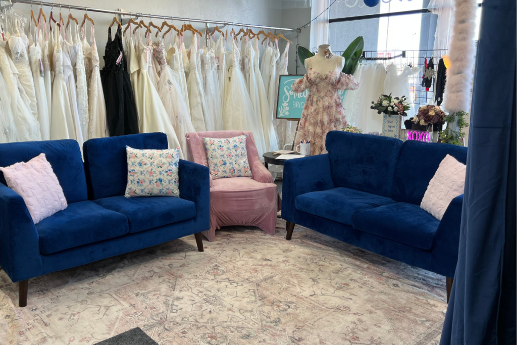 Interior of a romantic bridal boutique featuring designer bridal gowns and a cozy space where brides shop bridal for their wedding day.