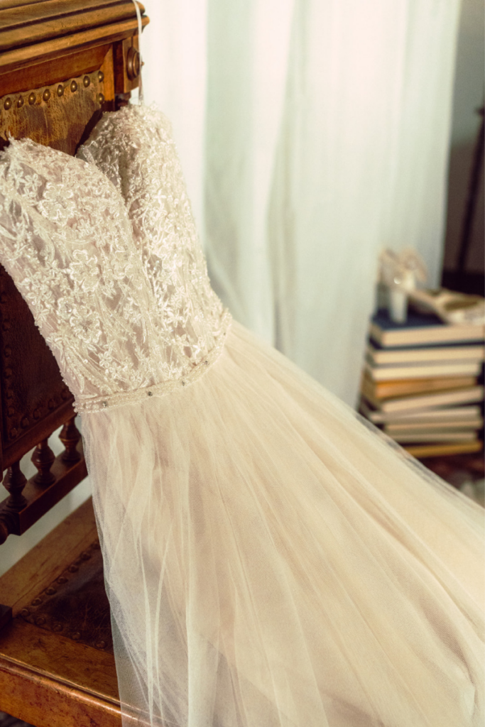 Lace and tulle designer bridal gown displayed in a romantic bridal boutique, inspiring brides to shop bridal for elegant designer bridal gowns.