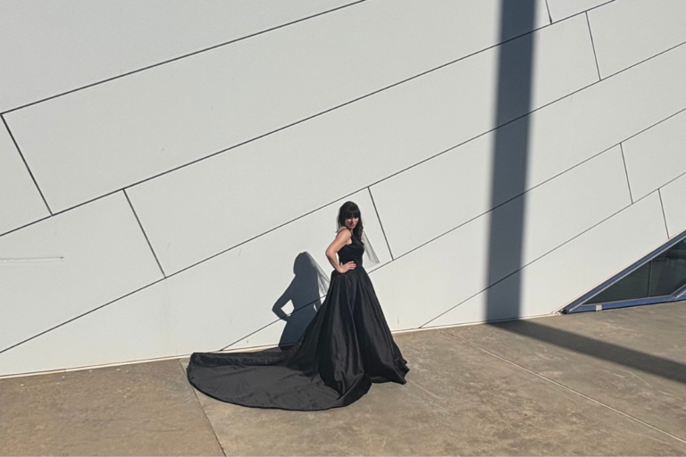 Model wearing a dramatic black formal gown with a long train from The Formal Niche in Oklahoma City.