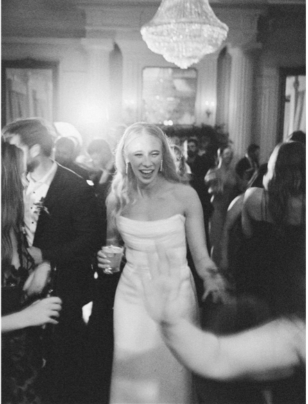 Bride celebrating on the dance floor during her wedding, showcasing a personalized wedding and timeless wedding style. Photo by The Lockharts Photo & Film | Dallas & NYC.