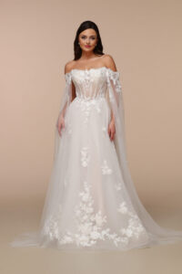 Romantic lace wedding dress with an off-the-shoulder corset bodice and flowing sleeves inspired by 2027 Wedding Dress Trends.