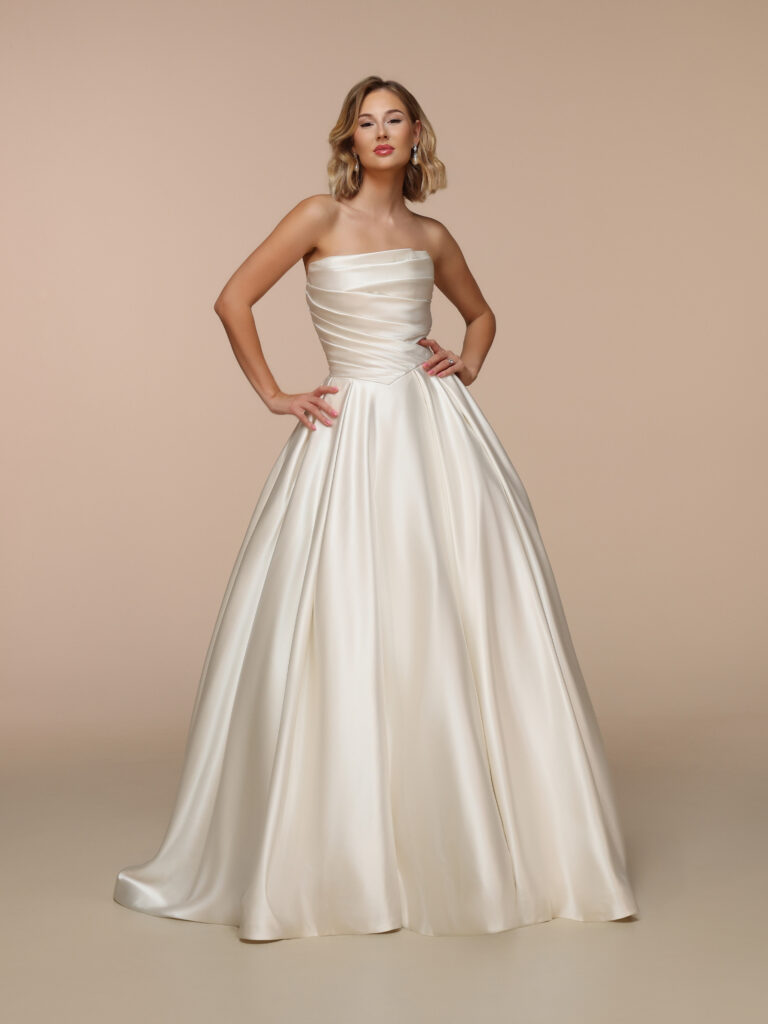 Ivory satin Basque waist wedding dress with a strapless draped bodice and full skirt showcasing 2027 Wedding Dress Trends.